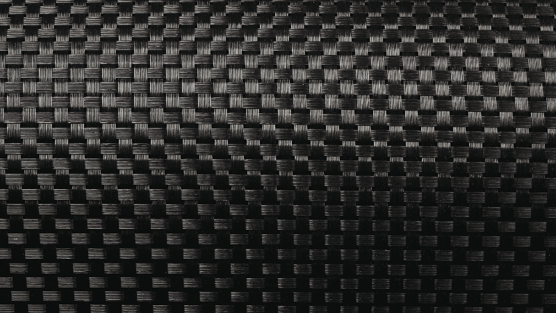 A macro close-up of high-performance quarter-zip fabric showing the engineered micro-mesh texture designed for breathability and moisture-wicking.